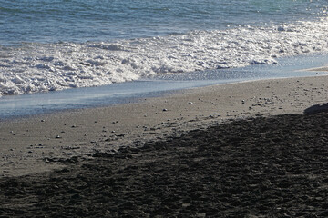 Reynisfjara - black beach in Iceland, close-up on waves