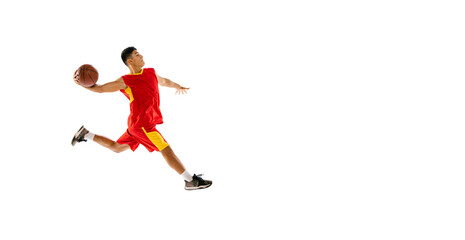 Fototapeta na wymiar Portrait of young man, basketball player throwing ball into basket in a run isolated over white studio background. Flyer