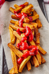 golden french fries on a white wooden rustic background