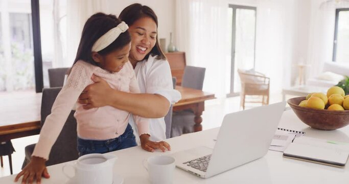 Daughter and working mother, single parent or small business entrepreneur typing on a laptop, pointing at the screen while doing remote work from home. Parent showing a child her work or startup job