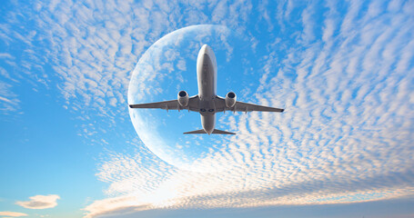 White passenger airplane in the sky  with full moon  - Travel by air transport "Elements of this image furnished by NASA"