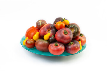Various tomato colors piled up on a green plate