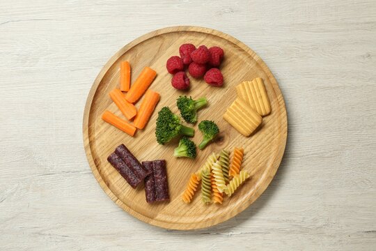 Board With Different Finger Foods For Baby On Wooden Table, Top View