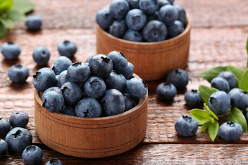 Tasty fresh blueberries on wooden table, closeup