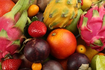Assortment of fresh exotic fruits as background, top view