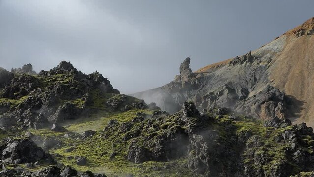 Steam emitting from fumarole in geothermal area of Hverir. Sulphur dioxide erupting from volcanic crater at Namafjall. Geyser in famous tourist attraction in Iceland