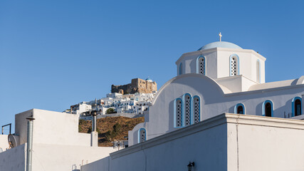 Fototapeta na wymiar Agios Nikolaos church on Astypalea Island with Guerini Castle in the background.