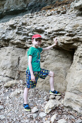 Kid in grotto of Belaya river valley