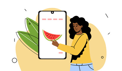 the girl chooses products online. Farm fruits in the app, food delivery to the house. Contactless purchase. The girl next to the phone.