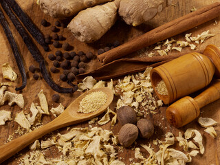An assortment of spices, ginger; allspice; vanilla bean; cinnamon stick; dried ginger; nutmeg, with...