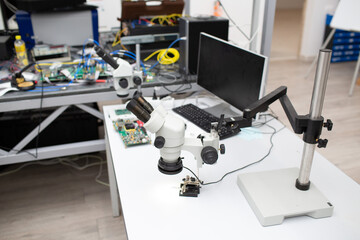Fototapeta premium Microscope and electronic board in Scientific research tech Laboratory on table.