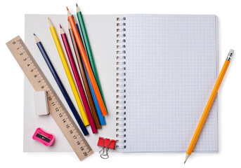 School notebook with colored pencils and a ruler on a white background. Top view. Place for text.
