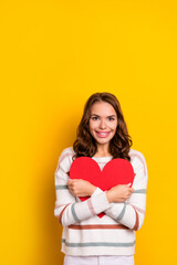 Vertical closeup photo of young attractive smiling happy lady hold red paper heart gift love boyfriend isolated on yellow color background