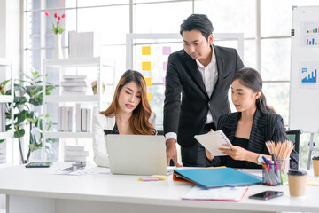 Professional Asian business adviser meeting to analyze and discuss the strategy of financial support of a tech company. Partnership start-up consultant, Indoor business client consultation concept.