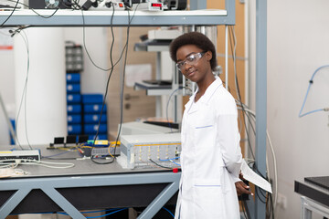 Scientist african american woman working in laboratory with electronic tech single photon detector. Research and development of electronic devices by color black woman.