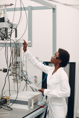 Scientist african american woman working in laboratory with electronic tech single photon detector. Research and development of electronic devices by color black woman.