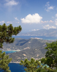 Panoramic vertical view of Elba island landscape shaped by mountains covered with cedar forests,...