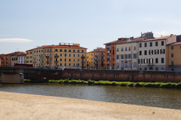 Fototapeta na wymiar Old houses at the Arno river in Pisa, Italy 