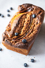 Banana bread with blueberries on a gray background.
