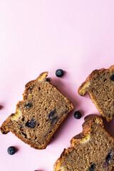 Banana bread slices with blueberries on a pink background. Flat lay and top view. - 524276713