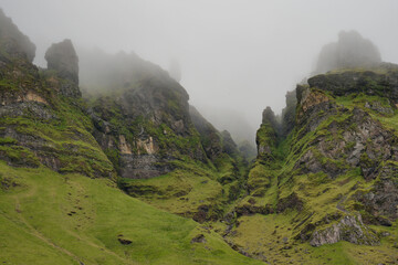 Wild volcanic mountains in the mist at Holt, South Iceland.