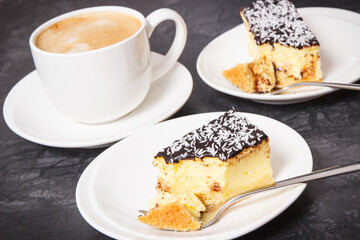 Fresh baked cheesecake and coffee with milk. Delicious dessert