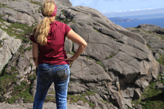 A woman has dirty jeans from hiking on the difficult Brufjell hiking trail - Norway