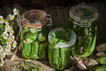  Salted, pickled cucumbers in a jar on an old wooden table