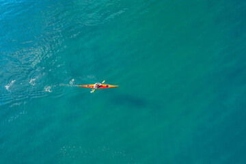 Red or yellow kayak with man sea, open space, aerial top view