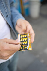 Istanbul, Turkey- 09.10.2022:  A man hand scratching turkish lottery card with coin. The focus is...