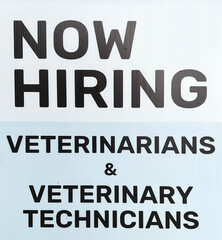 Help wanted sign looking for veterinarians and vet technicians. - 524282781