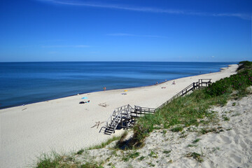 Endless beach on the Curonian Spit (Kurshskaya Kosa). Blue calm Baltic Sea. Kaliningrad region