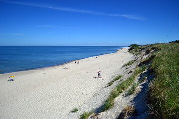 Endless beach on the Curonian Spit (Kurshskaya Kosa). Blue calm Baltic Sea. Kaliningrad region