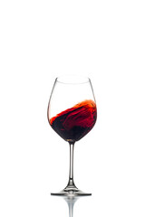 Red wine swirl in a wine glass isolated on a white background. 