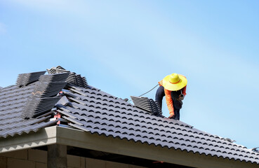 Homeworker doing roofing without safety protective gear, house construction, work safety concept