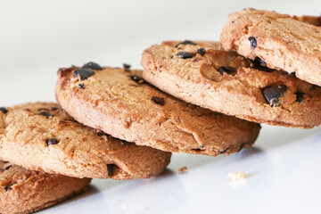 Close up of delicious chocolate chip cookies showing their texture, tasty biscuit snack