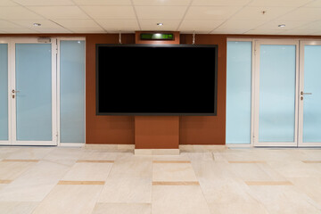 Modern business lobby of a hotel or office with a large information screen