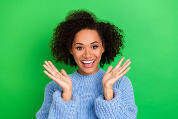 Photo of cheerful toothy beaming girl with perming coiffure dressed blue sweater hold hands near...