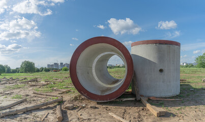 Reinforced concrete storm sewer pipes of large diameter stacked at a construction site. Sewer Large diameter pipes.