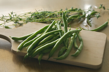 fresh green beans on a wooden table