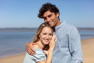 young couple hug and enjoy life together at the beach