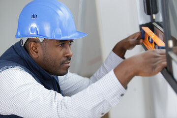 worker checks the level of a window