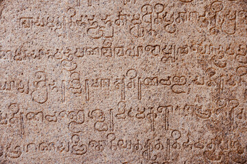 Inscriptions of ancient language carved on the stone walls at Hindu temple in Mahabalipuram, Tamilnadu, India. Ancient tamil inscriptions carved in the exterior temple walls in Mahabalipuram.