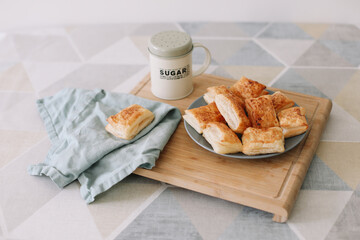 freshly baked homemade pastry on kitchen table. breakfast with puff buns and a glass of milk