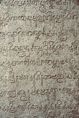Inscriptions of ancient language carved on the stone walls at Hindu temple in Mahabalipuram, Tamilnadu, India. Ancient tamil inscriptions carved in the exterior temple walls in Mahabalipuram.