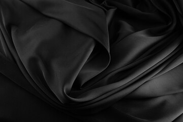 Folds of black silk fabric.