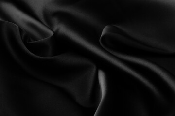 Folds of black silk fabric.