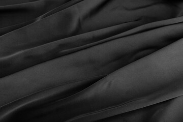 Folds of black silk fabric.