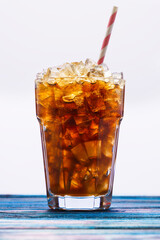 Alcoholic cocktail with rum and ice with the addition of cola in a glass, close-up