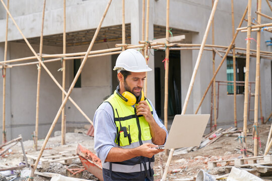 Foreman thinking with laptop on construction site for plan build up house